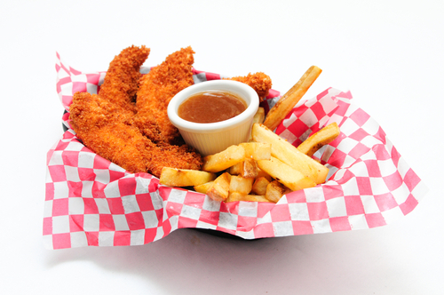breaded,chicken,strips,with,french,fries,and,dipping,sauce,in